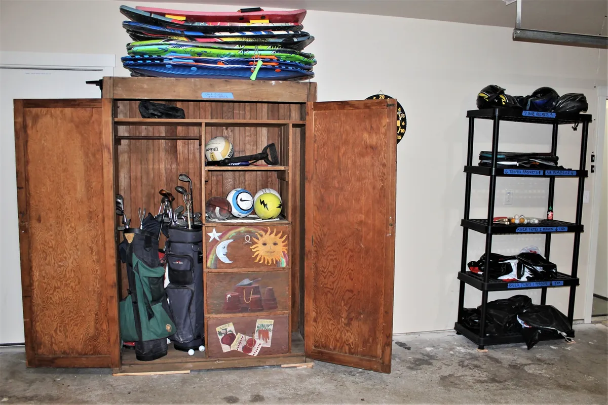 A practical indoor storage area featuring golf clubs, a variety of sporting gear, and organized shelves ready for adventure. The space suggests preparation for outdoor activities and an active lifestyle.